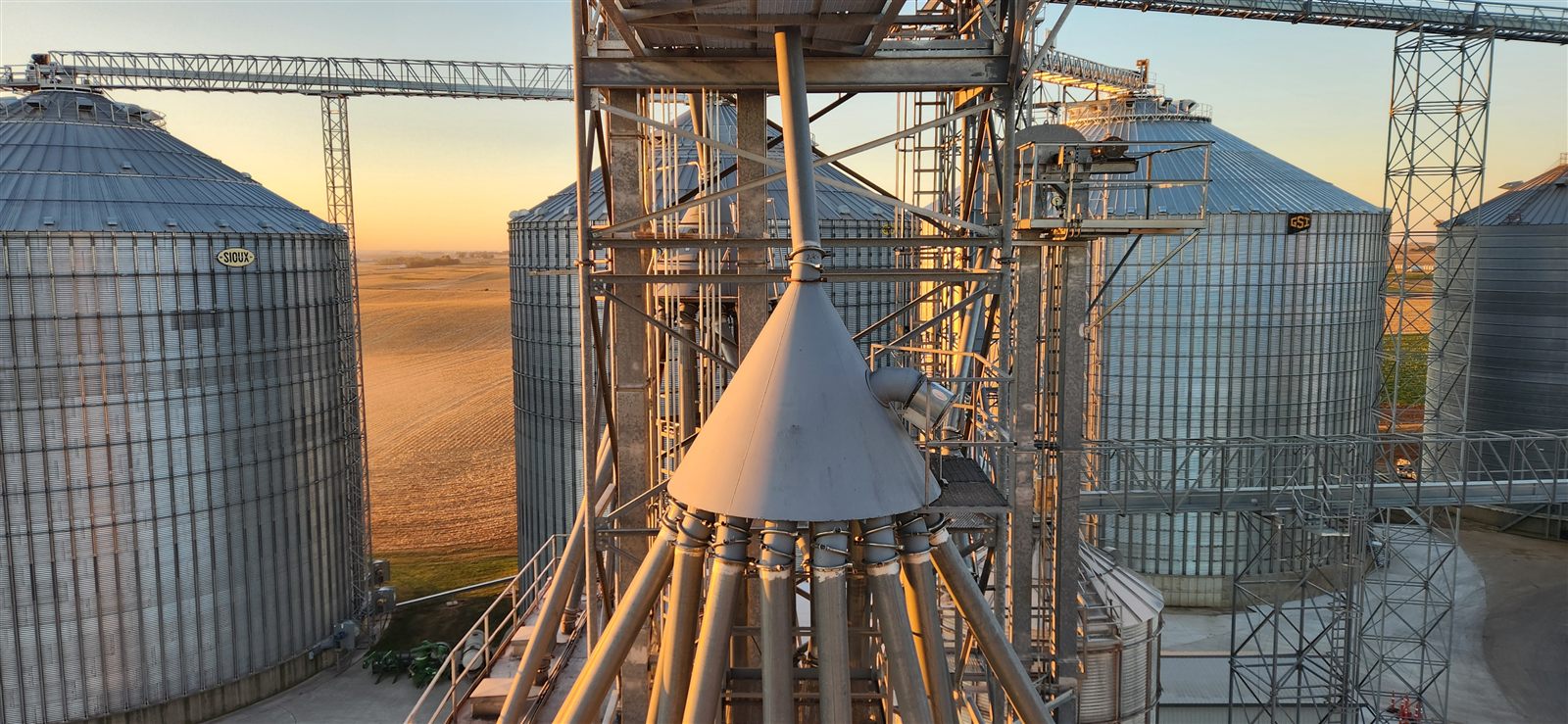 Distributor and spouting atop grain storage bins