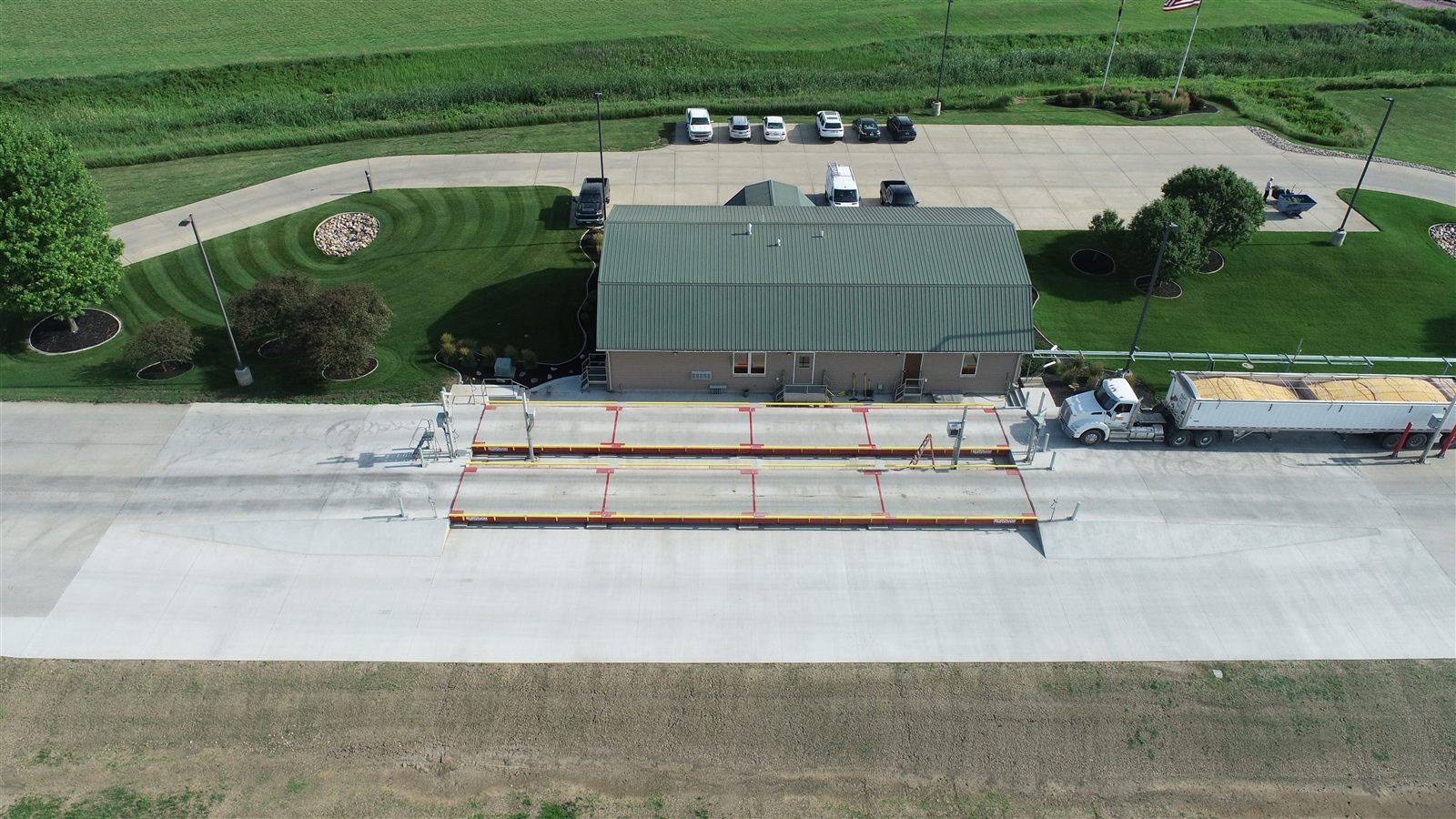 Aerial view of a completed grain facility scale house and truck scale