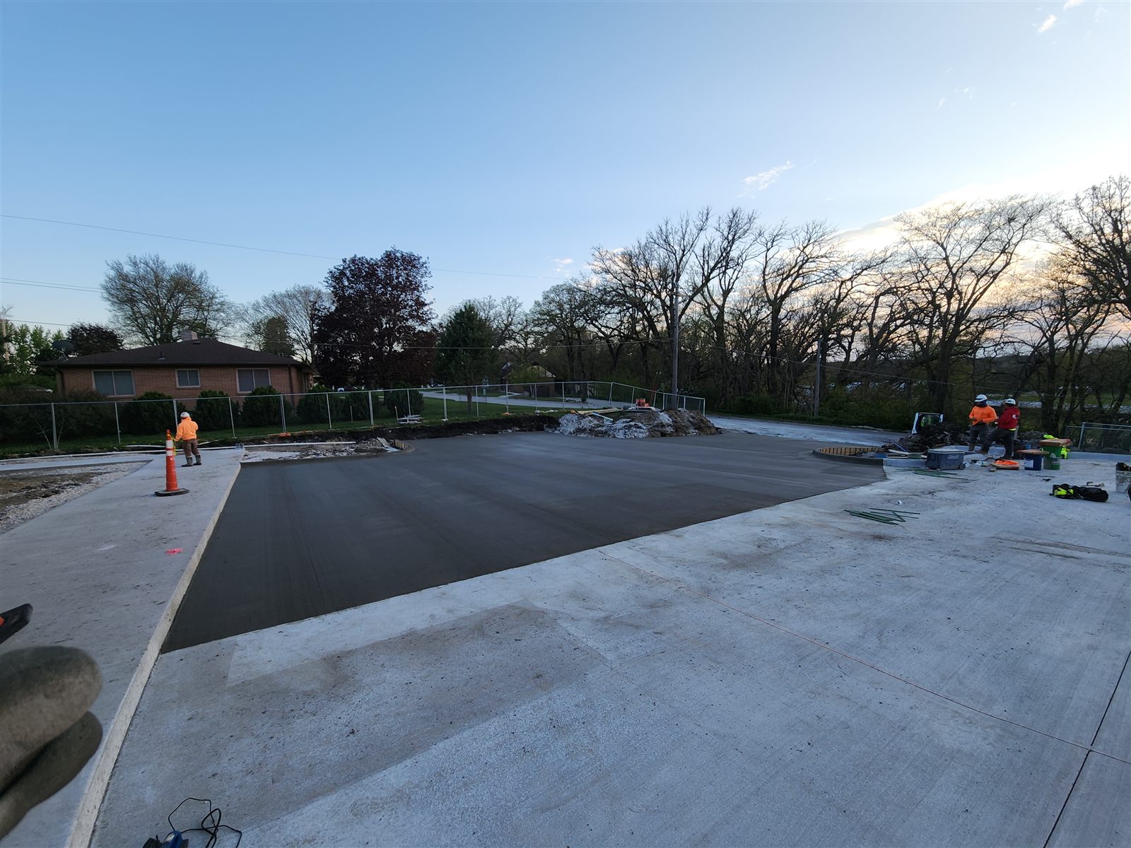 Fresh concrete paving placed beside a finished slab