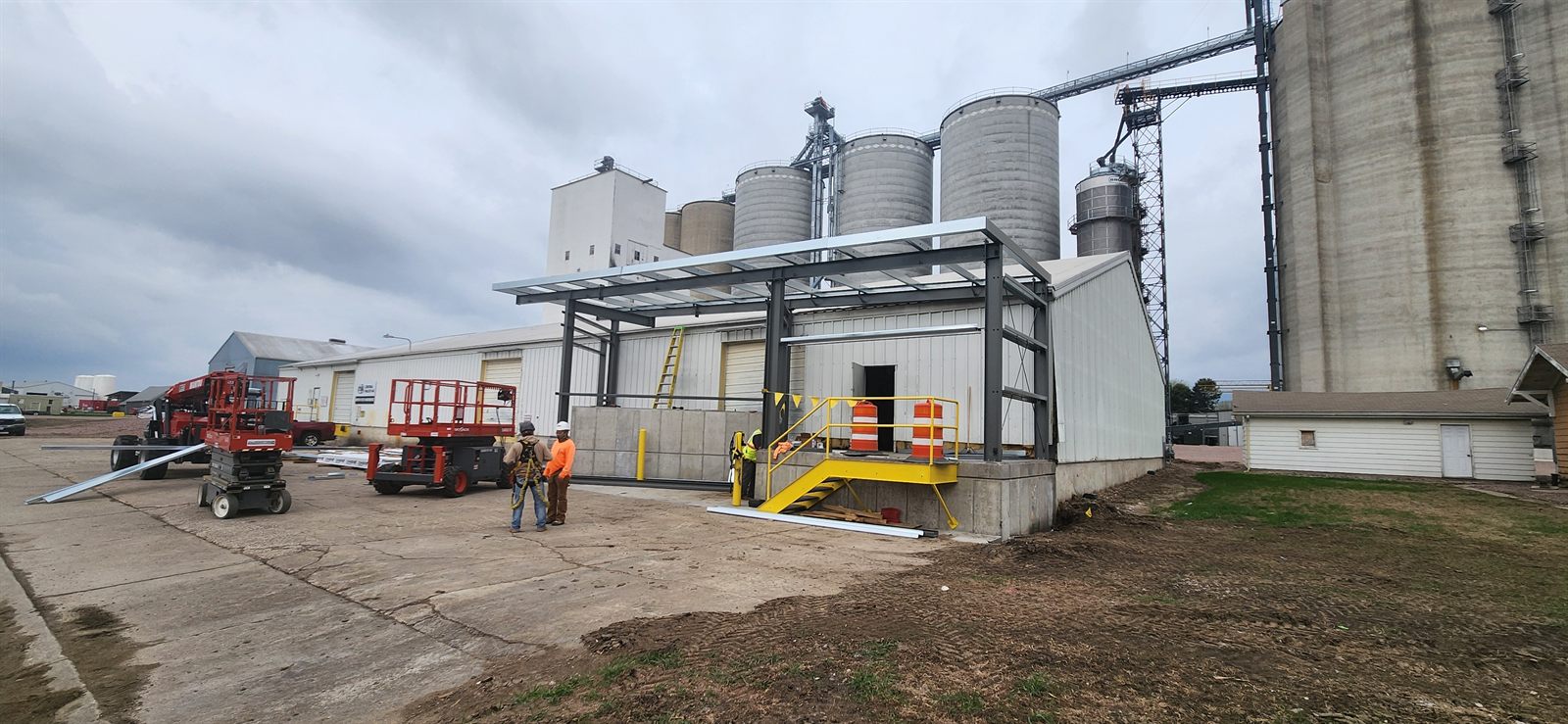 Crew erecting a new steel structure at a grain facility