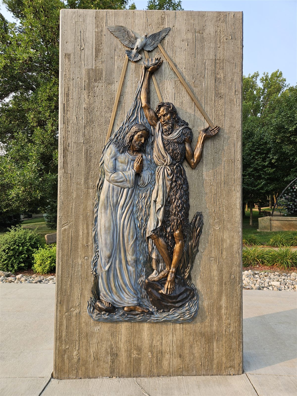Bronze relief memorial panel set in a decorative concrete monument
